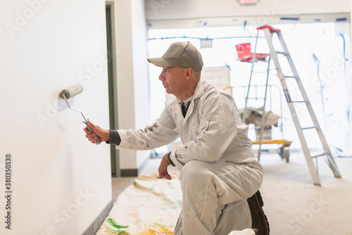 Manual worker painting wall