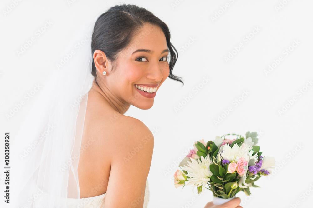Portrait of bride in veil holding bouquet Portrait of bride in veil holding bouquet