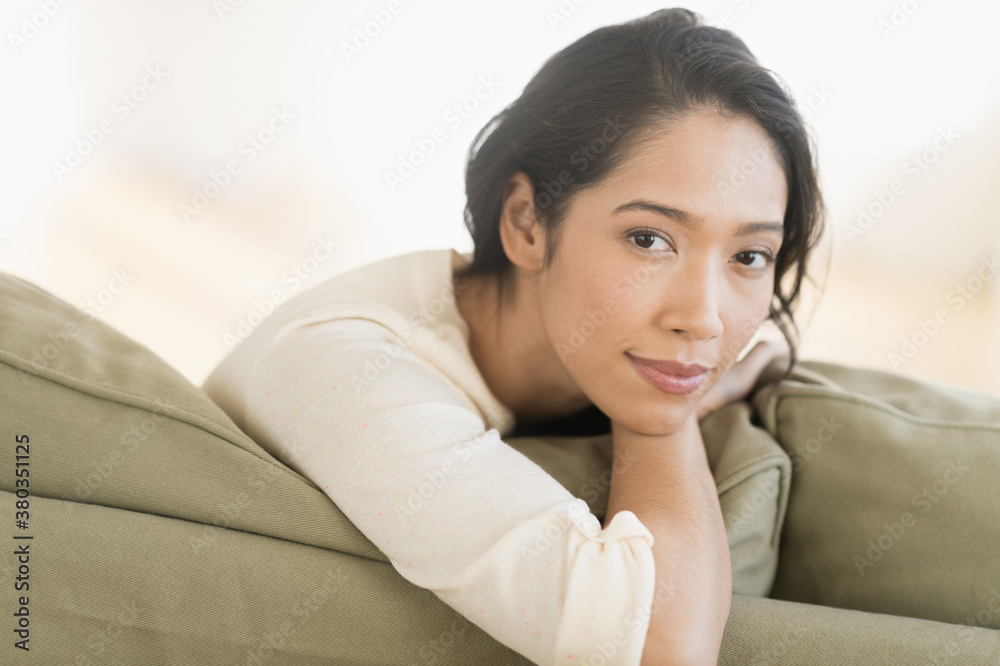 Portrait of young woman sitting on couch Portrait of young woman sitting on couch