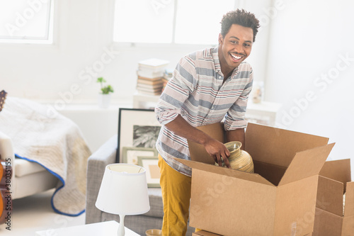 Man packing decors into cardboard box