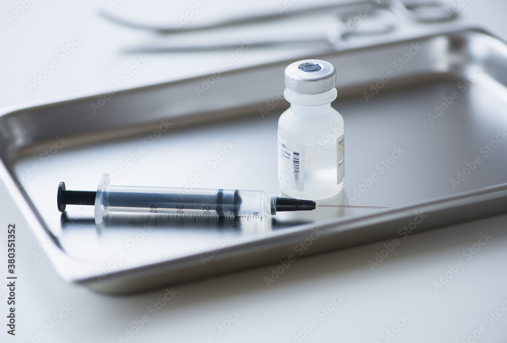 Close up of syringe and medication, studio shot Close up of syringe and medication, studio shot