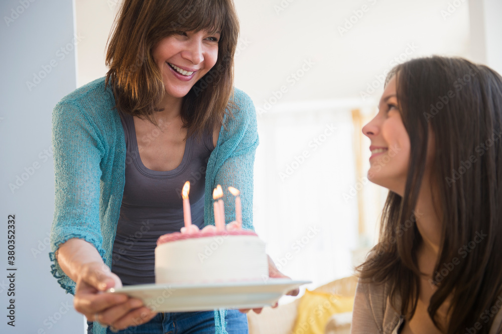 Teenage girl (14-15) celebrating birthday with her mom at home Teenage girl (14-15) celebrating birthday with her mom at home
