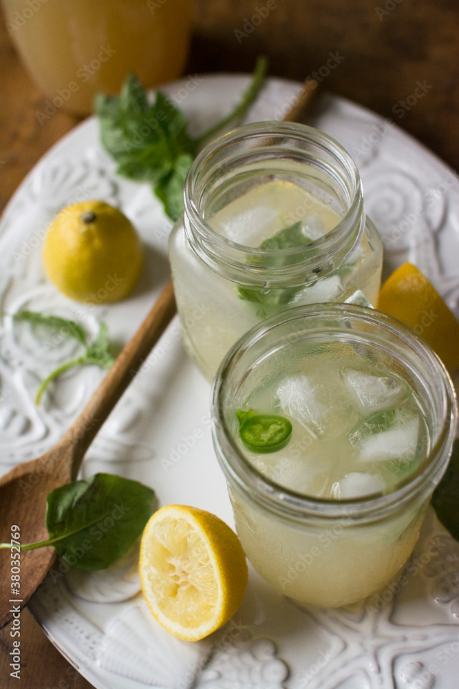 Studio shot of lemonade in jar and glass Studio shot of lemonade in jar and glass