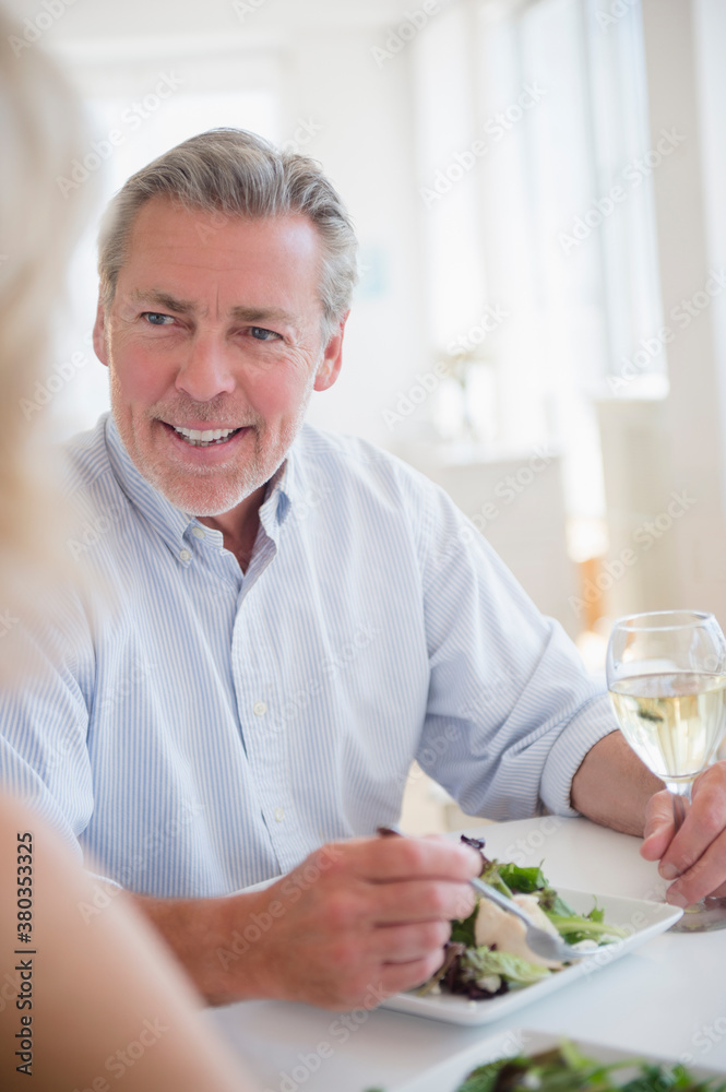 Portrait of man eating and drinking white wine at restaurant Portrait of man eating and drinking white wine at restaurant