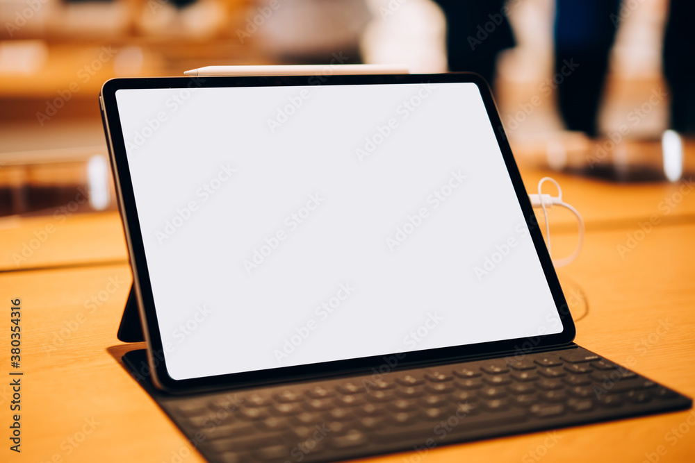 Mockup of tablet on wooden table Mockup of tablet on wooden table