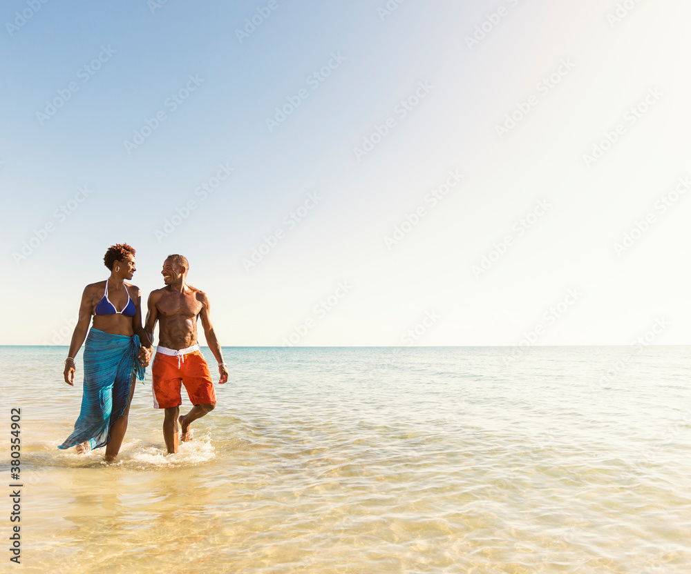 Mature couple walking in sea Mature couple walking in sea