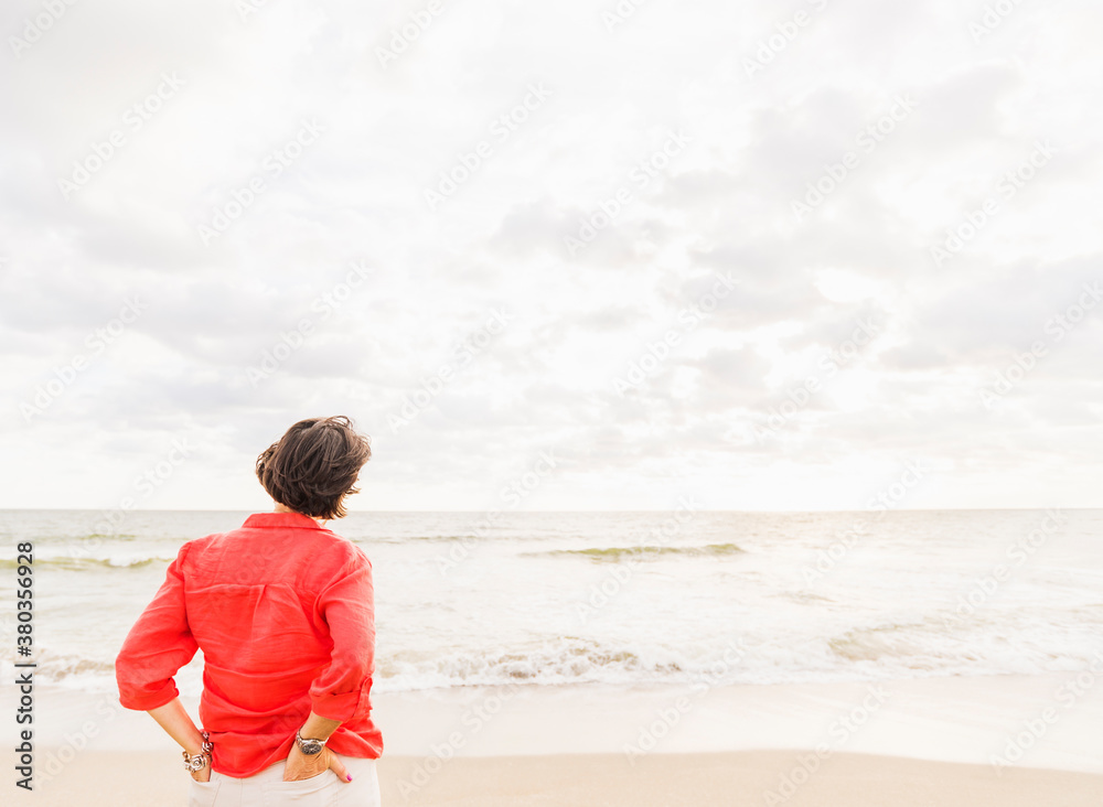 Rear view of woman looking at ocean Rear view of woman looking at ocean