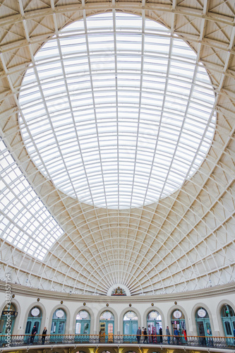 Architectural ceiling of Corn Exchange market in Leeds, England with people in the lower part of the picture.
