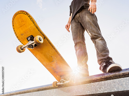 Man with skateboard at the edge of ramp