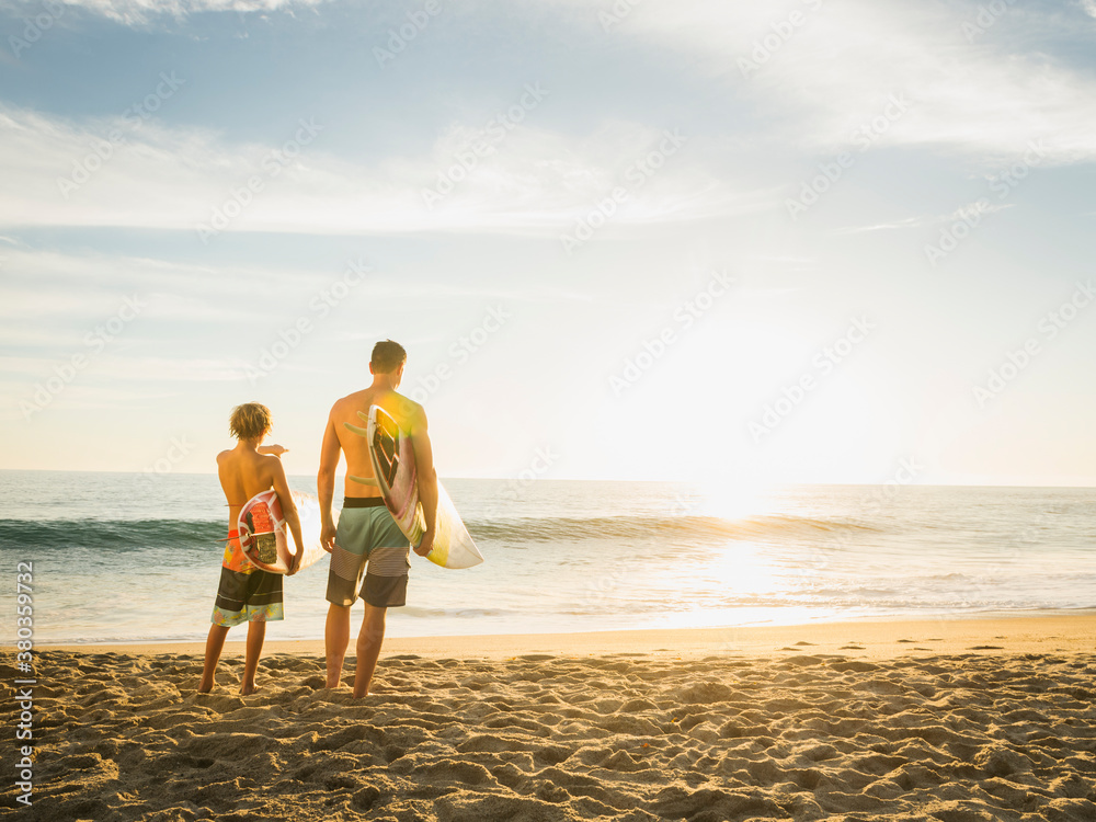 Father and son (14-15) looking at sea Father and son (14-15) looking at sea