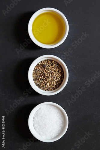 Olive oil, pepper and salt in ramekins