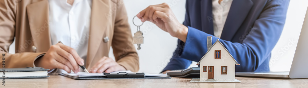 Real estate agent holding a key and asking costumer for contract to buy, get insurance or loan real estate or property. Real estate agent holding a key and asking costumer for contract to buy, get insurance or loan real estate or property.