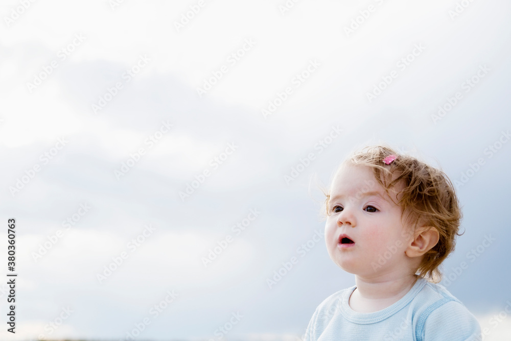 Baby girl (6-11 months) looking away Baby girl (6-11 months) looking away