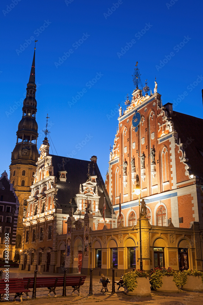 Illuminated House of the Blackheads and St. Peter's Church against blue sky Illuminated House of the Blackheads and St. Peter's Church against blue sky