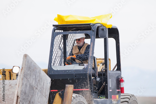 Senior man working on earthmover photo