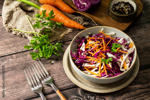 Salad Cole Slaw. Autumn Cabbage salad in a bowl on a rustic wooden table. Copy space.