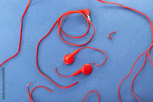 Headphones on a white background. Torn headphones. Repair of electronic devices. Broken wire.