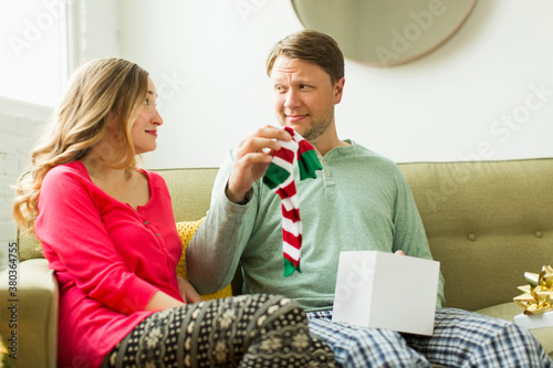 Man holding unwanted Christmas gift
