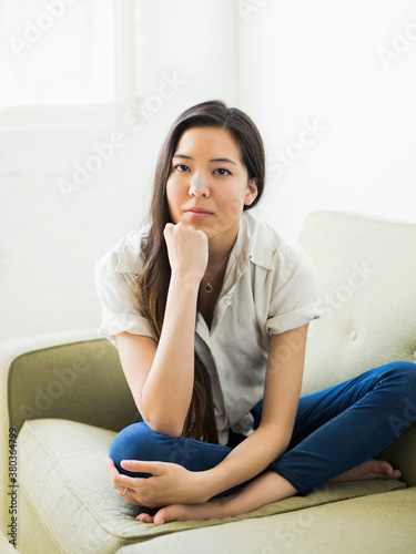 Portrait of woman sitting on sofa