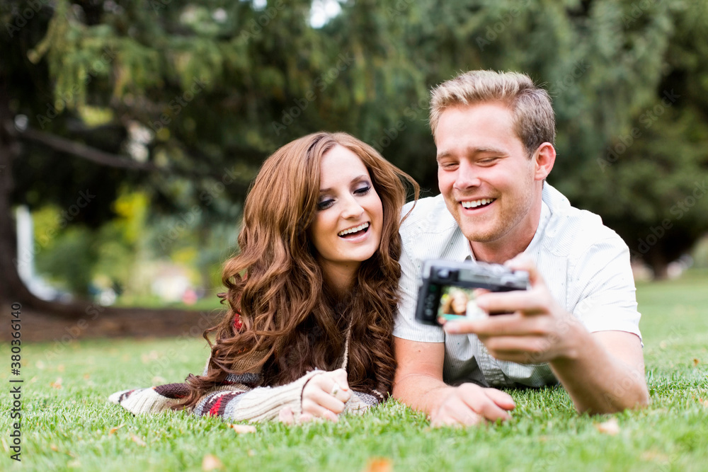 Portrait of young couple taking selfie in park Portrait of young couple taking selfie in park