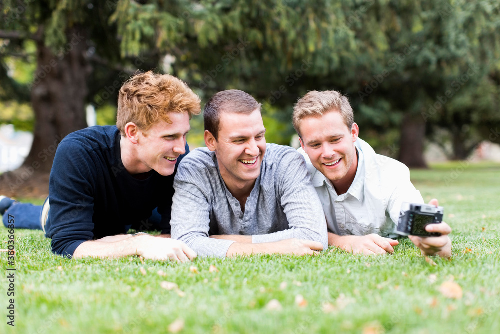 Portrait of young men taking selfie in park Portrait of young men taking selfie in park