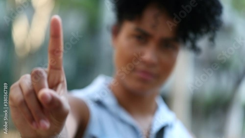 Black woman shaking finger in negation, person saying no with hand photo