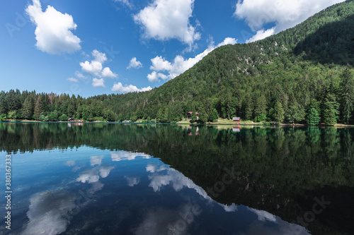 UDINE  ITALY  - APRIL 20  2020  Superior Fusine Lake with Mount Mangart on the background. Fusine Lakes Natural Park  Tarvisio  Udine province  Friuli Venezia Giulia  Italy.