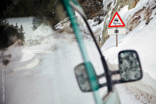 Winter snow warning, Slippery road in the snow road sign, Alps mountains, Switzerland, Europe