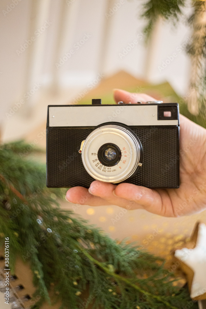 retro analog photo camera in Christmas scenery.
