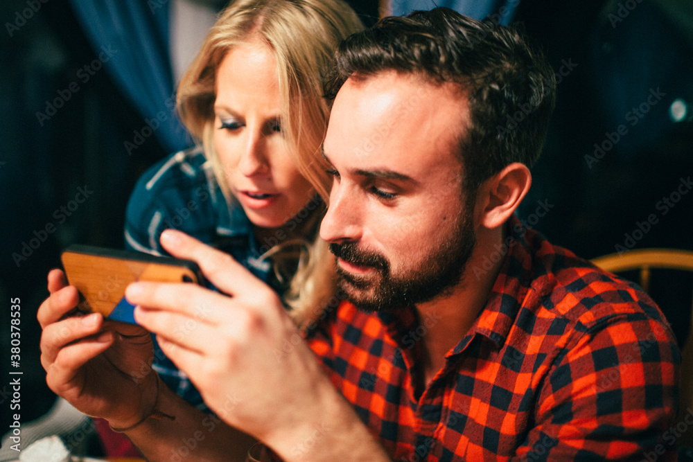 Two friends look at text messages on the phone Two friends look at text messages on the phone