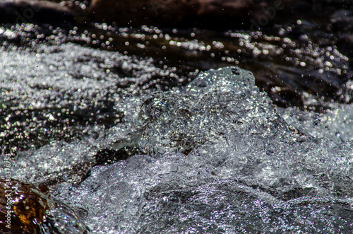 in summer rocky mountain river water silk. mountain river