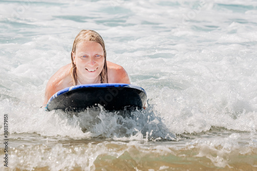Woman surfing in waves of Atlantic Ocean © amelie
