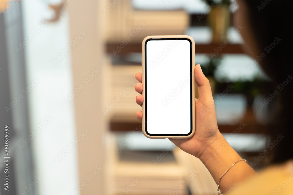 Woman hand's holding empty screen mobile phone at cafe. Woman hand's holding empty screen mobile phone at cafe.