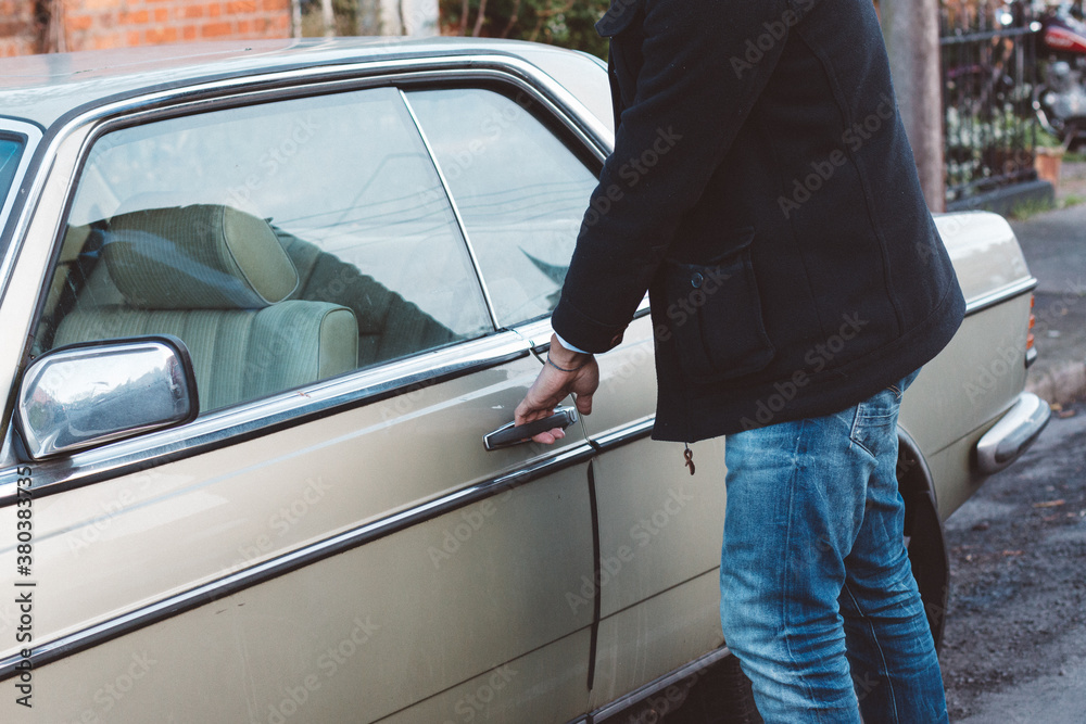 Man approaching his car parked on the street