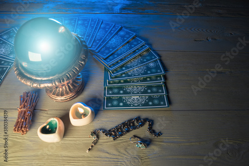 Crystal ball and tarot cards on fortune teller table background