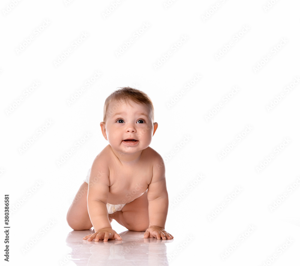 Happy smiling baby on floor over white background Happy smiling baby on floor over white background