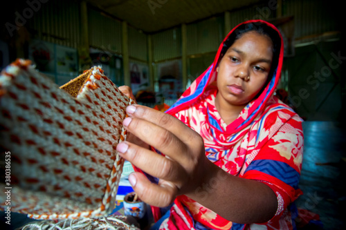 A young crafts maker is making a showpiece from the fibers of a banana tree at Madhupur, Tangail, Bangladesh. photo