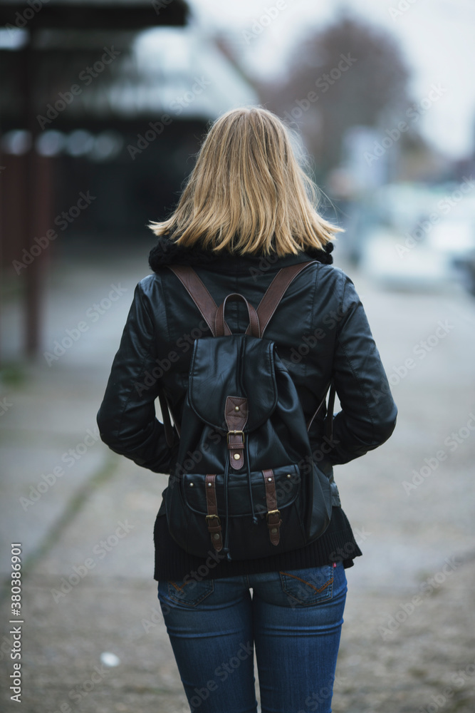 Back view of a woman wearing a backpack Back view of a woman wearing a backpack