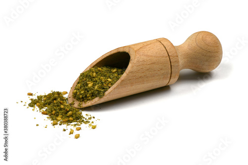 Za'atar (zatar), blend of herbs, sesame seeds and salt in pile on white background. photo