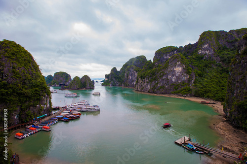 Tourist junks floating among limestone rocks at early morning in Ha Long Bay, South China Sea, Vietnam, Southeast Asia. Five images panorama