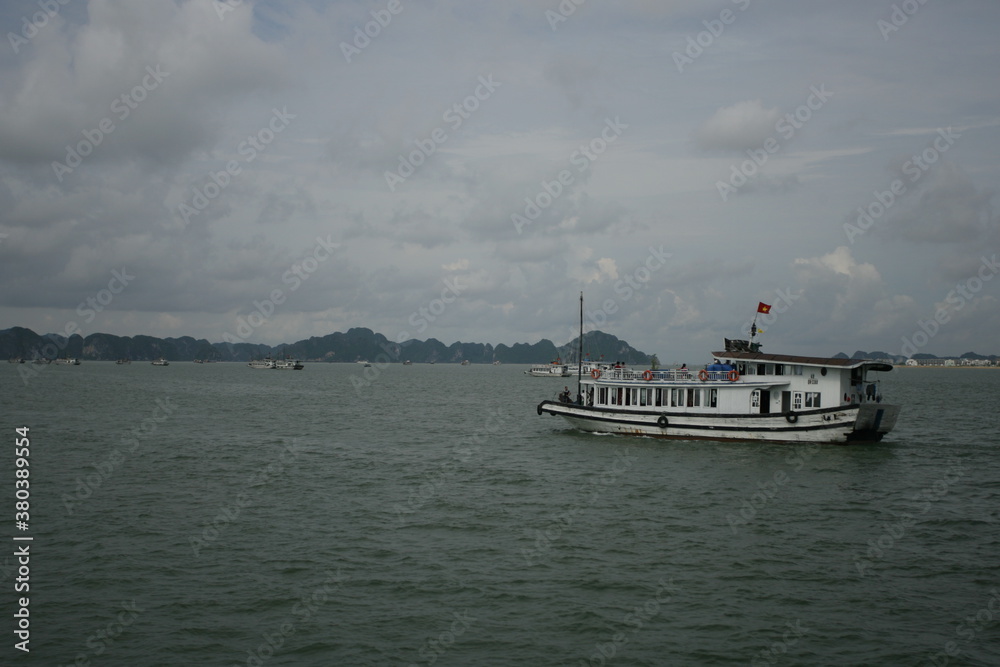 Tourist junks floating among limestone rocks at early morning in Ha Long Bay, South China Sea, Vietnam, Southeast Asia. Five images panorama Tourist junks floating among limestone rocks at early morning in Ha Long Bay, South China Sea, Vietnam, Southeast Asia. Five images panorama