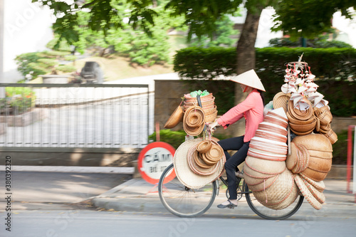 HANOI, VIETNAM - FEB 21: A small market for vendor in early morning in Hanoi, Vietnam on February 21, 2016. Vietnam florist vendor selling flowers on bicycle in small market or on street in Hanoi.