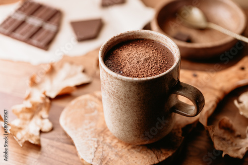 Close-up of hot chocolate on the table. Autumn or winter cozy still life.