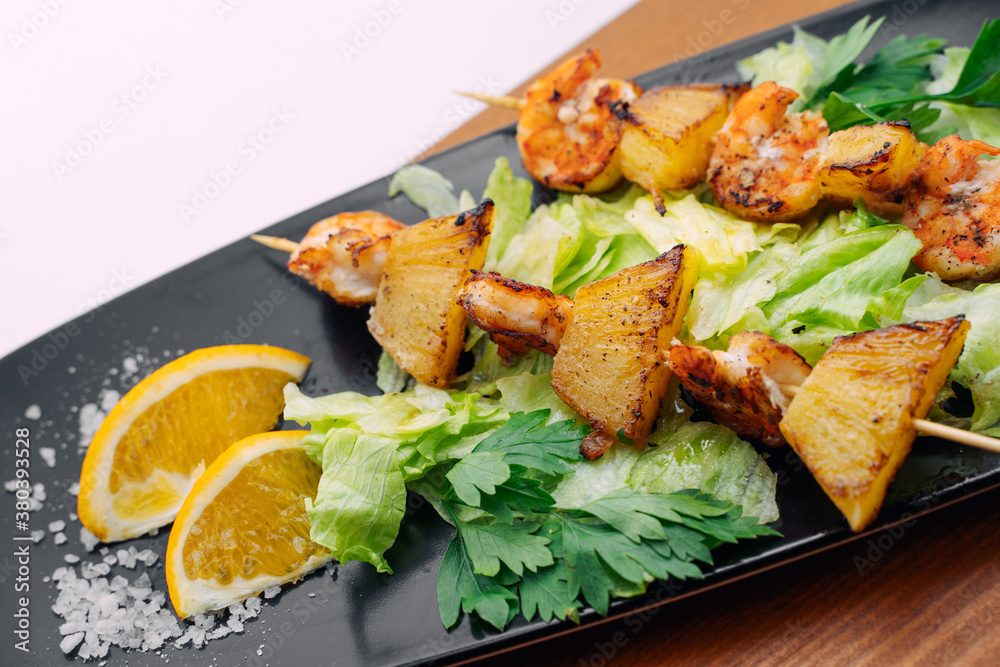 tiger prawns with pineapples in a black plate tiger prawns with pineapples in a black plate