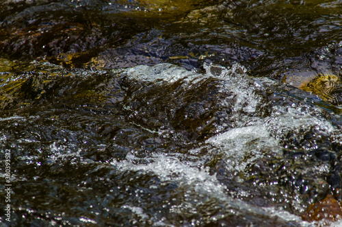 in summer rocky mountain river water silk. mountain river