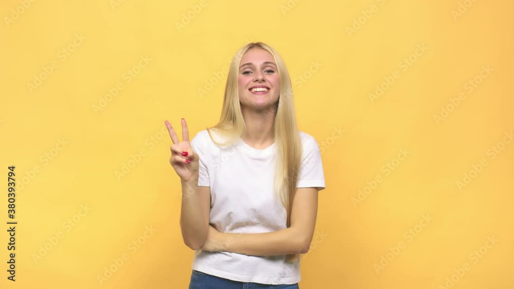 Young caucasian blonde woman showing number two with fingers Young caucasian blonde woman showing number two with fingers