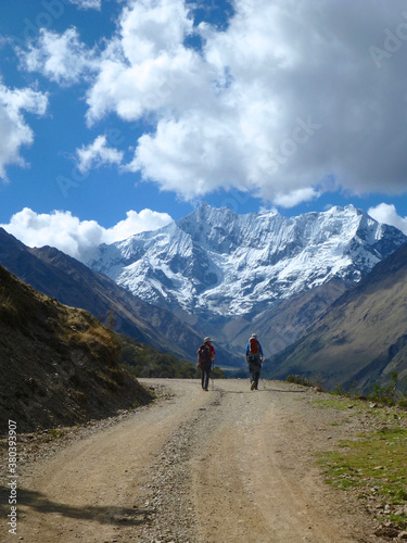 Hikers on the Salkantay trek in Peru, with snow capped mountains in the distance
