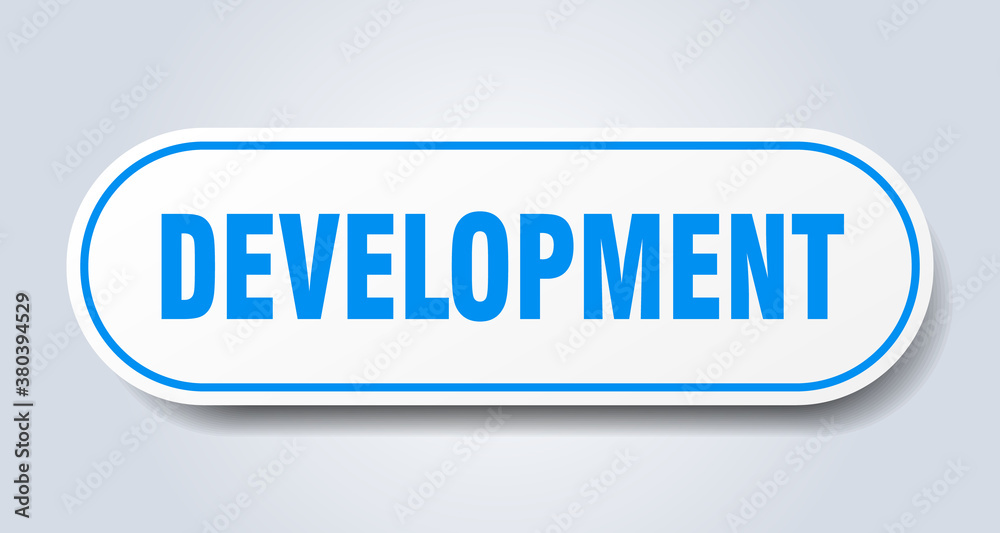 development sign. rounded isolated button. white sticker development sign. rounded isolated button. white sticker