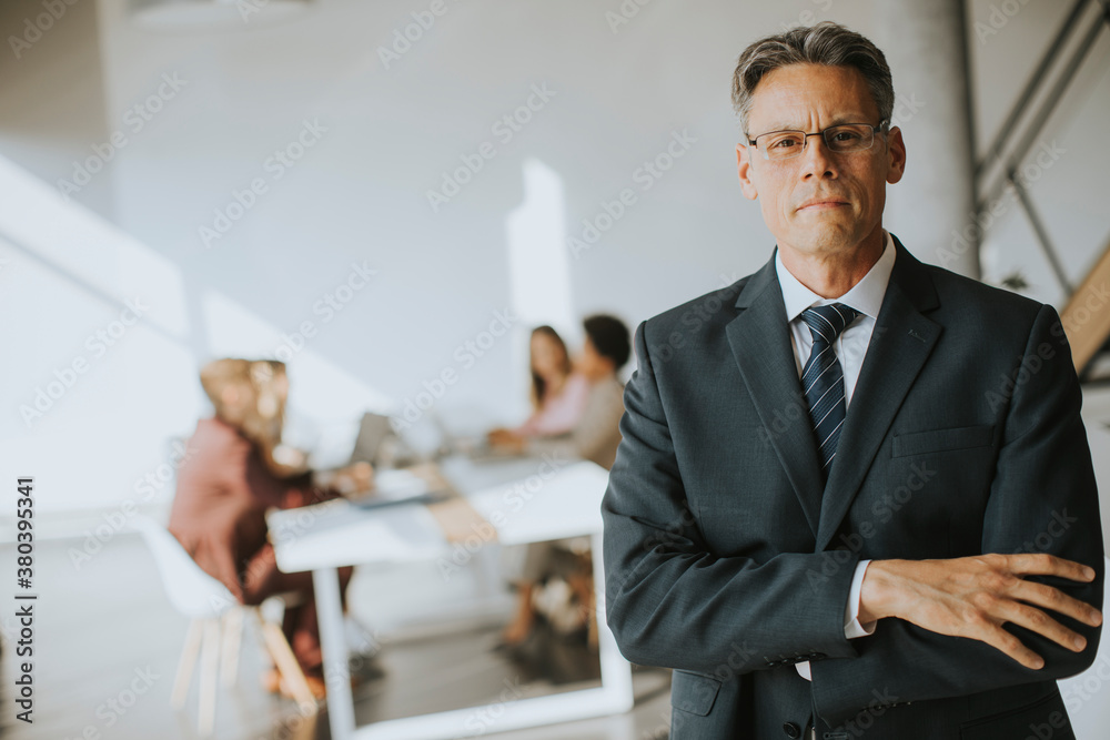 Handsome business man standing in the office Handsome business man standing in the office