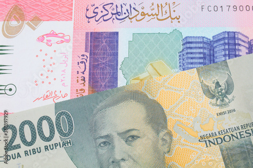 Wallpaper Mural A macro image of a grey two thousand Indonesian rupiah bank note paired up with a colorful fifty pound bank note from Sudan.  Shot close up in macro. Torontodigital.ca